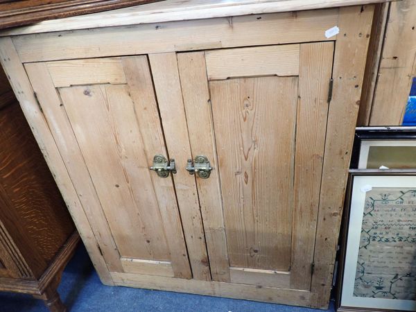 A VICTORIAN STRIPPED PINE TWO-DOOR CUPBOARD