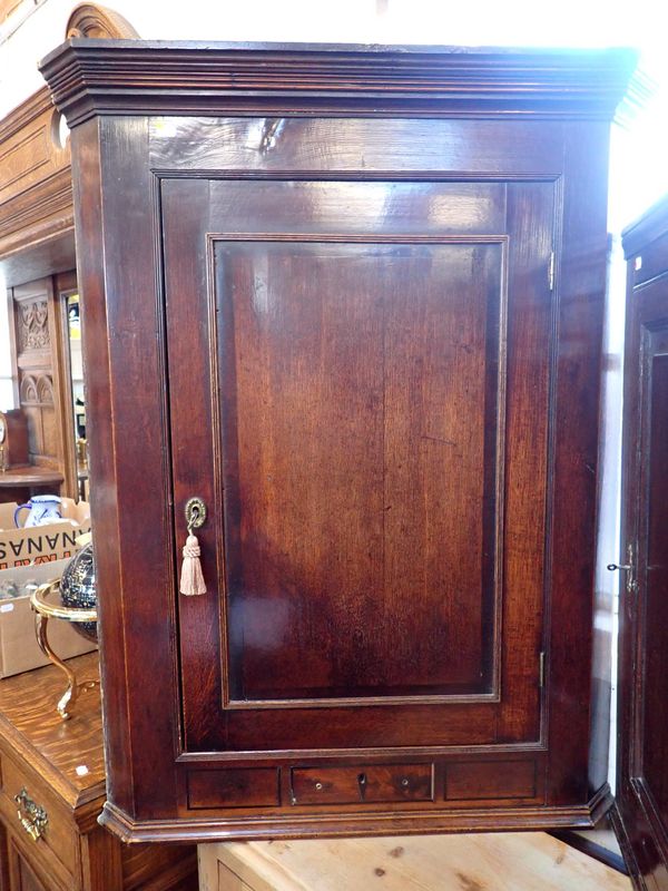 A GEORGE III OAK CORNER CUPBOARD