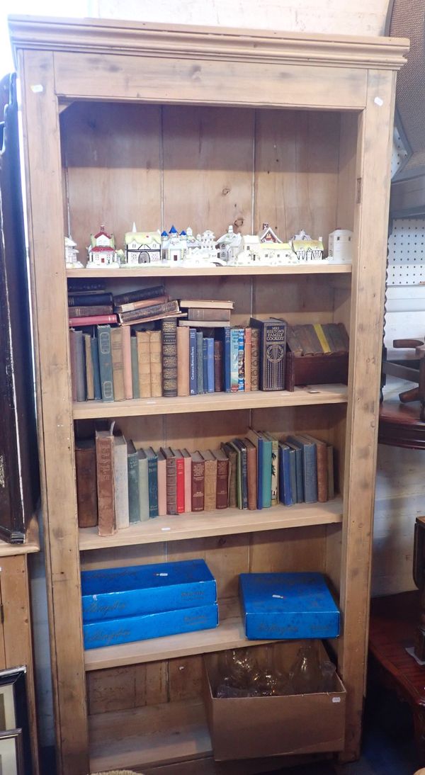 A TALL STRIPPED PINE OPEN BOOKCASE