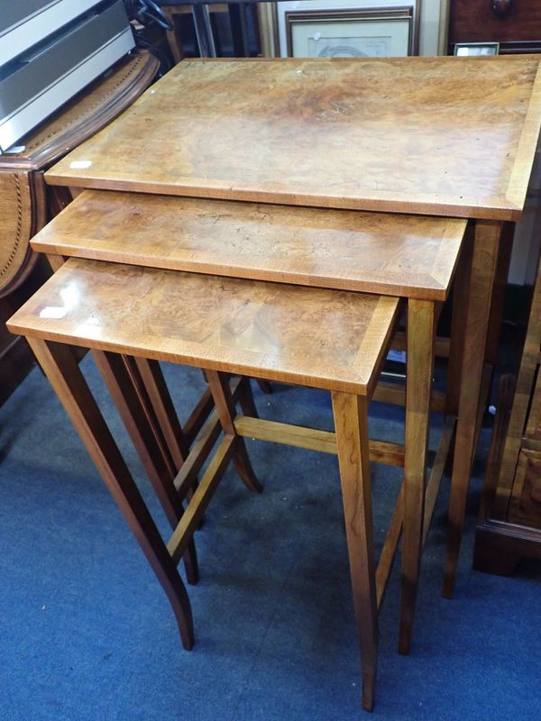 A NEST OF THREE EDWARDIAN STYLE BURR WALNUT AND MAHOGANY TABLES