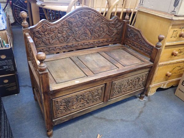 A HALL BENCH WITH CARVED PANELS