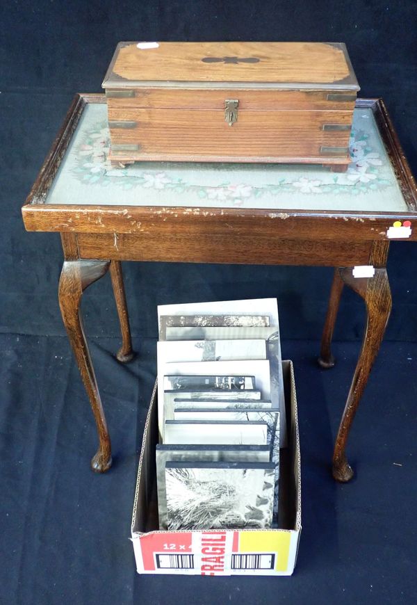 AN OAK OCCASIONAL TABLE WITH EMBROIDERED TOP, UNDER GLASS