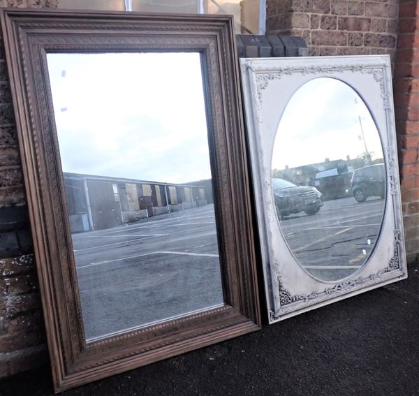 A LARGE WALL MIRROR, OVAL WITHIN A RECTANGULAR FRAME