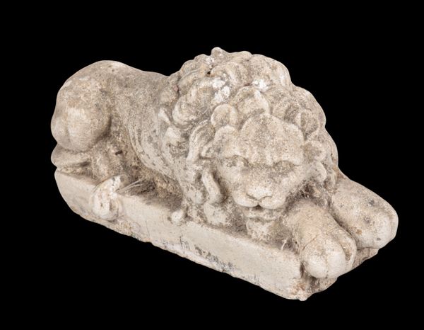 A COMPOSITE STONE MODEL OF A RECUMBENT LION