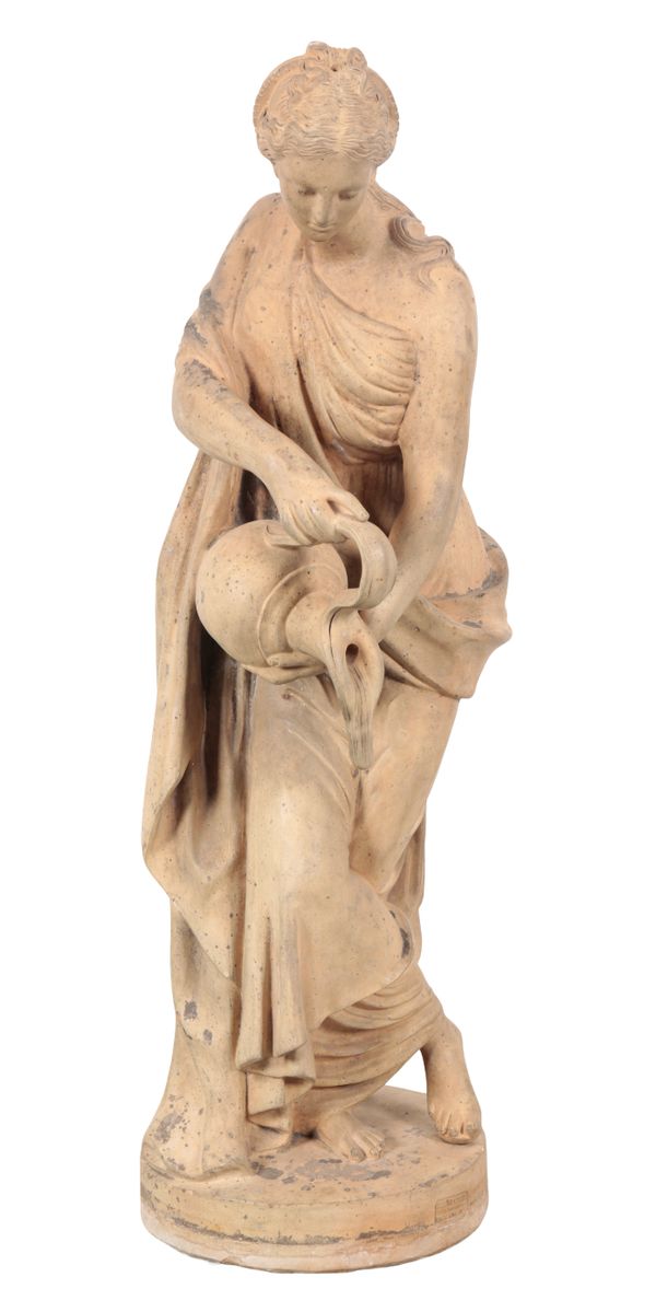 A FRENCH TERRACOTTA FIGURE OF A WOMAN WITH A WATER JUG