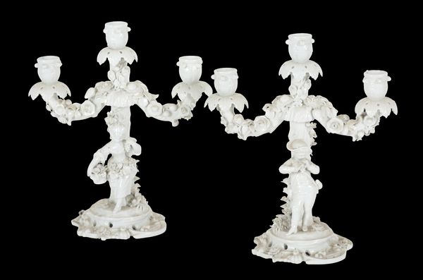 A PAIR OF 'MEISSEN' BLANC DE CHINE PORCELAIN FIGURAL CANDELABRA