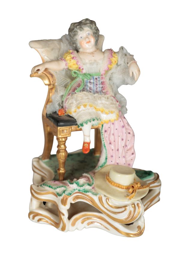 A 19TH CENTURY BLOOR DERBY PORCELAIN FIGURE OF A CHILD IN AN ARMCHAIR