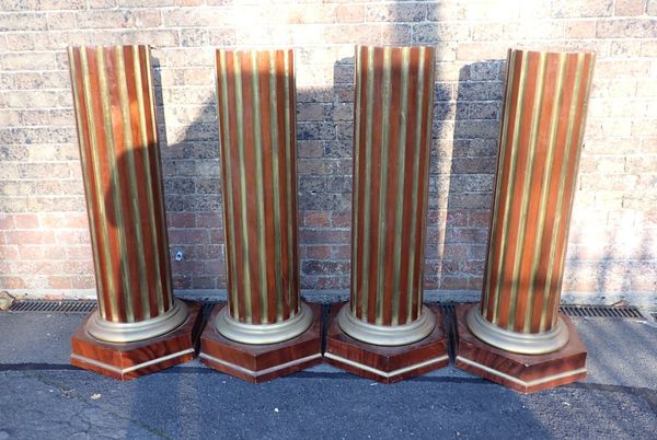 A SET OF FOUR MAHOGANY AND BRASS COLUMNAR BUST STANDS