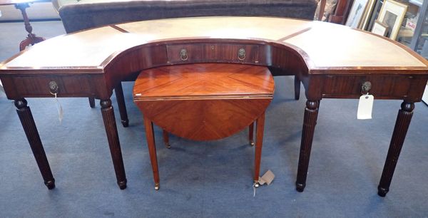 A  MAHOGANY WRITING DESK OF 'C' FORM