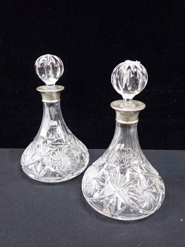 A PAIR OF SILVER COLLARED SHIP'S DECANTERS