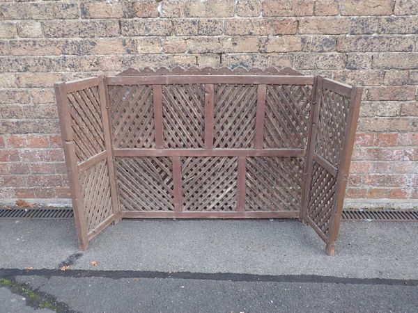 A WOODEN  WINDOW GRILLE OR SCREEN