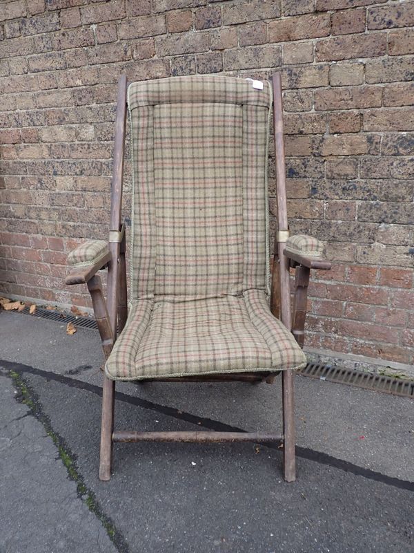 A CAMPAIGN STYLE ADJUSTABLE ARMCHAIR