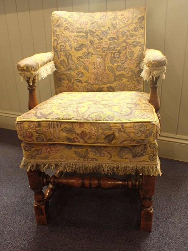 AN OAK-FRAMED UPHOLSTERED ARMCHAIR