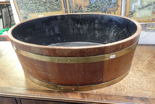 A BRASS BANDED TEAK COOPERED OVAL PLANTER