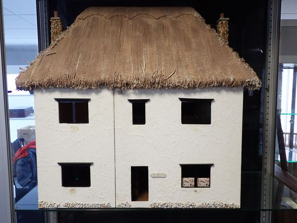 A THATCHED DOLLS HOUSE, IN THE STYLE OF MILTON ABBAS