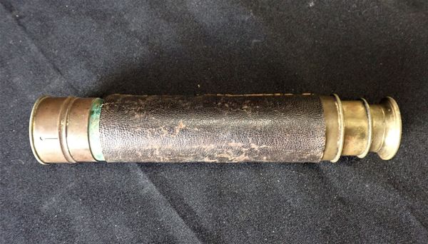 A 19TH CENTURY LACQUERED BRASS AND LEATHER COVERED THREE DRAW POCKET TELESCOPE