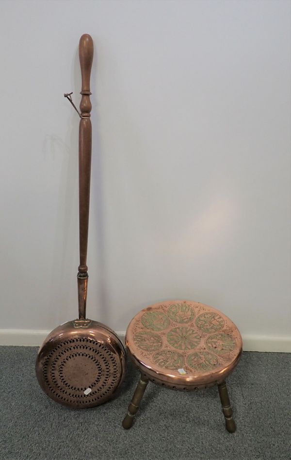 AN EASTERN BRASS AND COPPER STOOL, AND A WARMING PAN