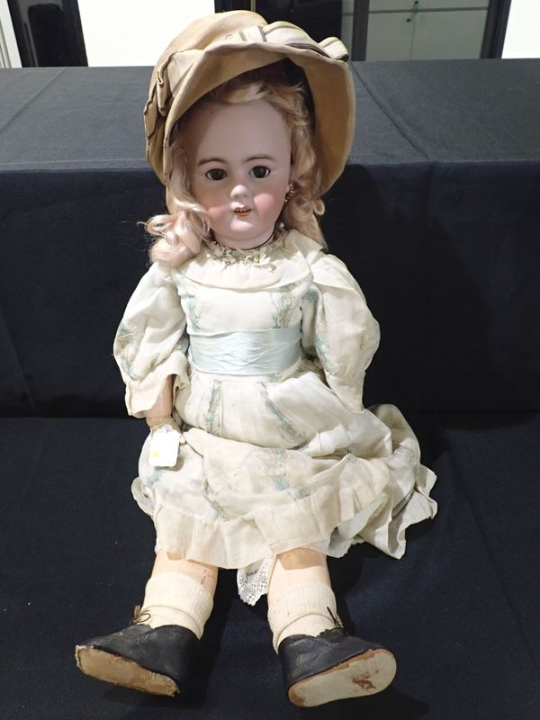 A LARGE BISQUE-HEAD DOLL