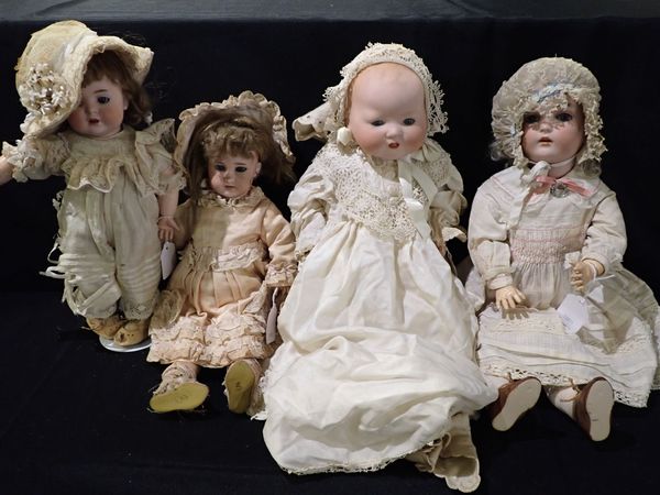 FOUR VARIOUS BISQUE HEAD DOLLS