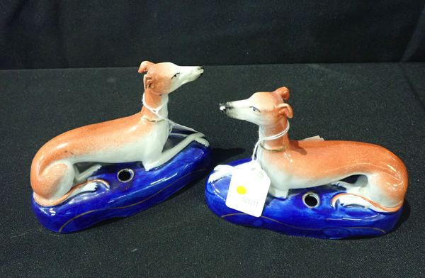 A PAIR OF STAFFORDSHIRE POTTERY GREYHOUND INKWELLS