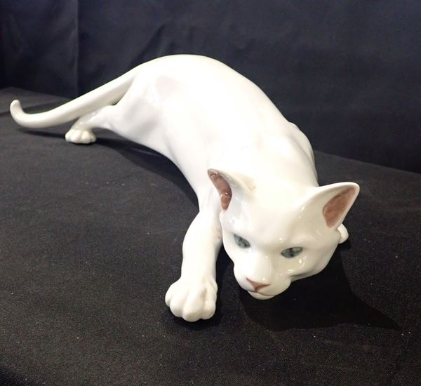 A ROYAL COPENHAGEN PORCELAIN FIGURE OF A PROWLING CAT