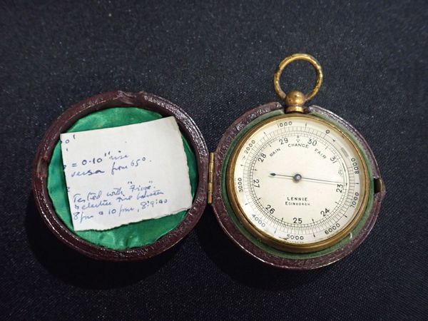 A LEATHER-CASED POCKET BAROMETER