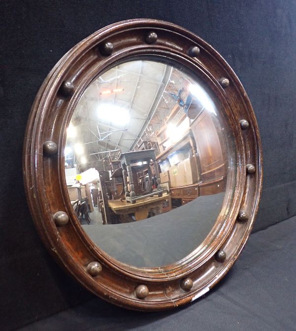 AN OAK FRAMED CONVEX MIRROR