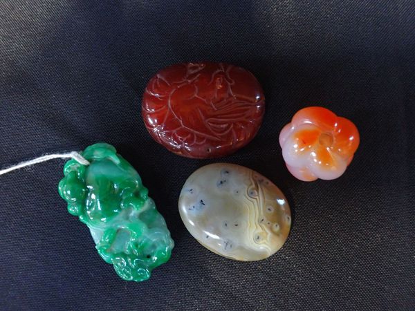 A CARVED JADEITE PENDANT