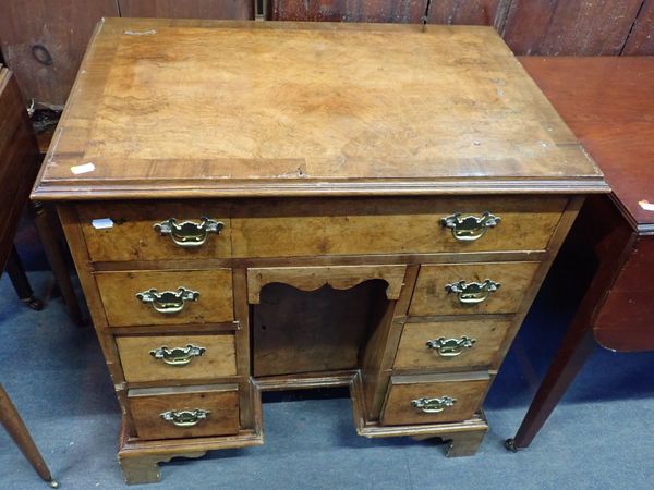 A GEORGE I STYLE FIGURED WALNUT KNEEHOLE DRESSING TABLE