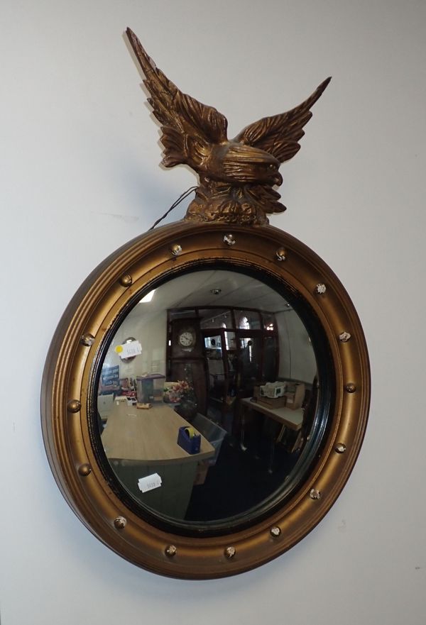 A CONVEX WALL MIRROR WITH EAGLE SURMOUNT