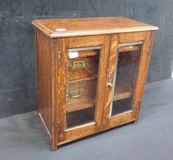 AN EDWARDIAN OAK SMOKER'S CABINET