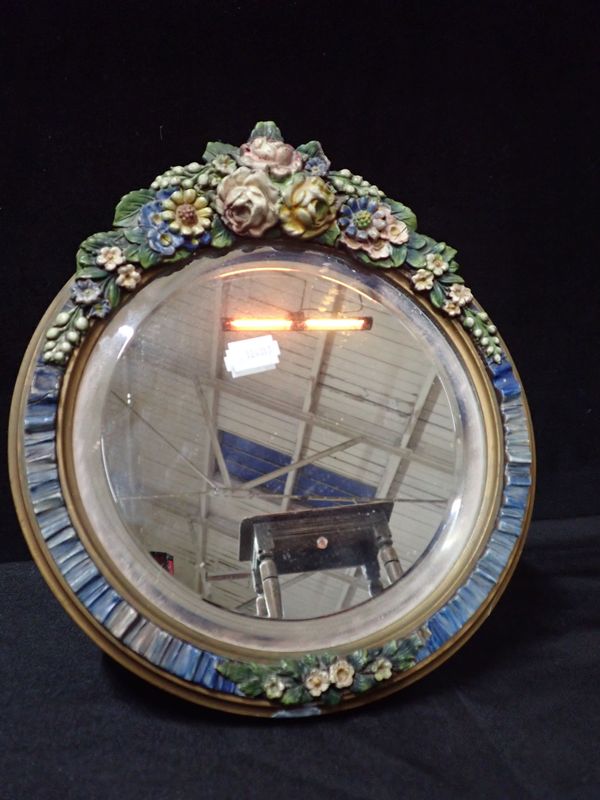 A CIRCULAR COLOURED BARBOLA MIRROR