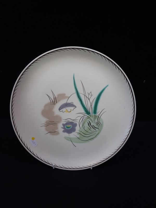 A POOLE POTTERY PLATE, PAINTED WITH STYLISED WATER LILIES