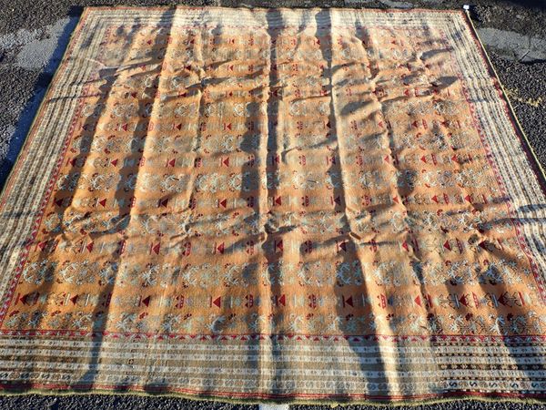 A PERSIAN RUG, ORANGE GROUND WITH SMALL MOTIFS