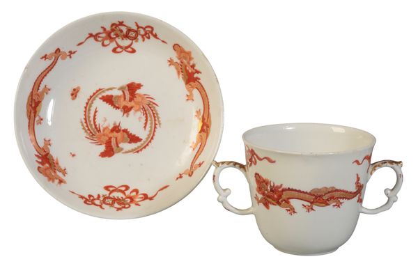 A MEISSEN RED DRAGON PATTERN TWO HANDLED BEAKER AND SAUCER