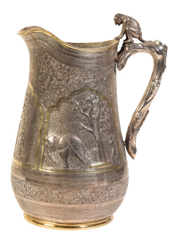 AN INDIAN CHASED AND REPOUSSE-DECORATED PARCEL-GILT SILVER EWER