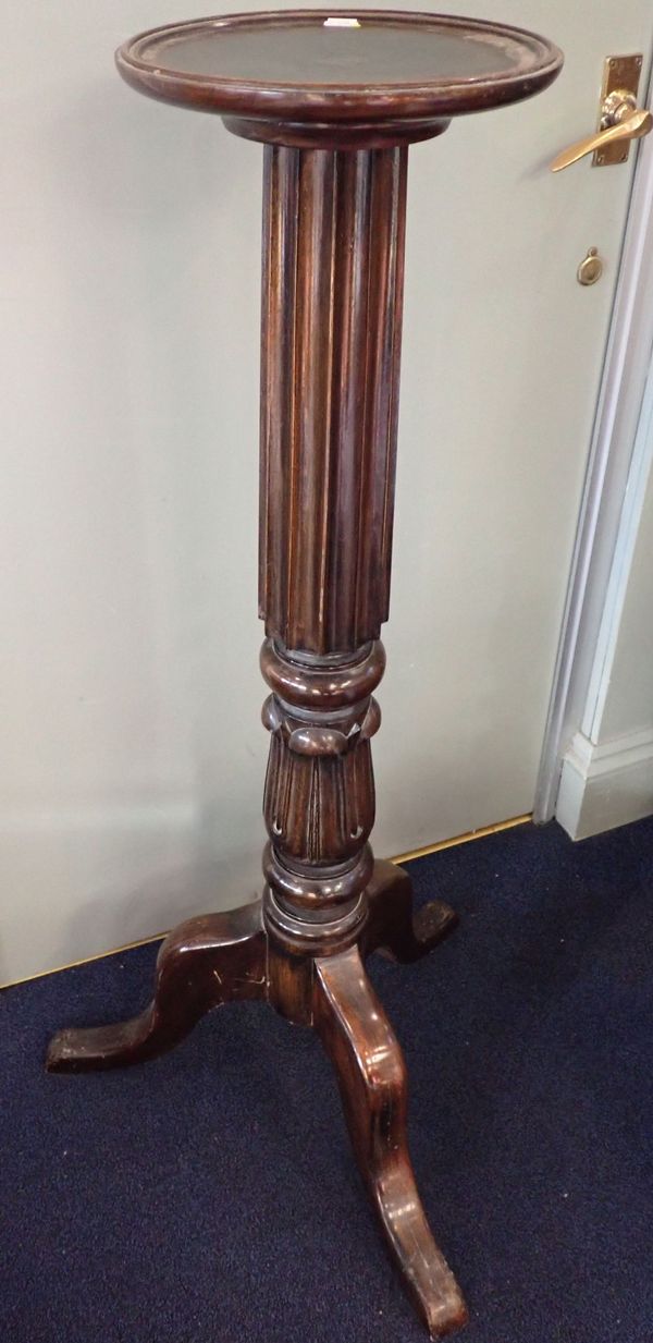 A MAHOGANY TORCHERE, ON CARVED AND FLUTED COLUMN