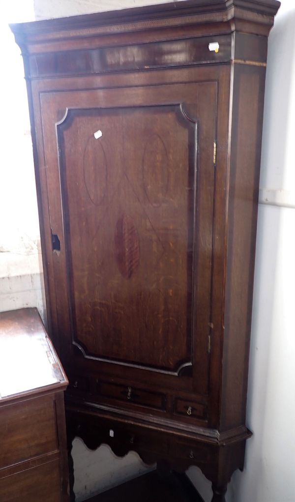 A GEORGE III OAK AND CROSSBANDED CORNER CUPBOARD