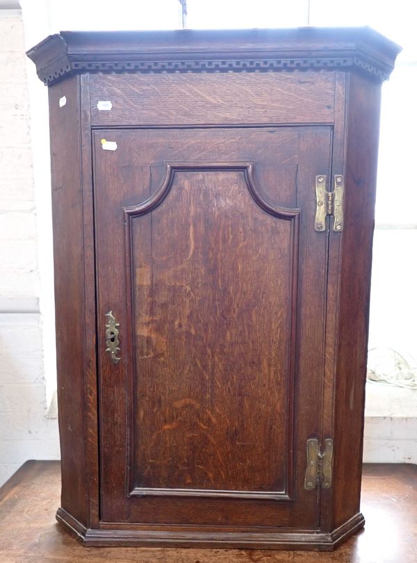 A GEORGE III OAK CORNER CUPBOARD