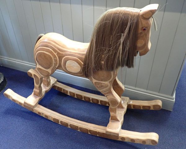 A CARVED LAMINATED WOOD ROCKING HORSE