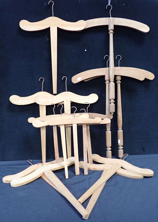 A COLLECTION OF LONG-HANDLED WOODEN HANGERS