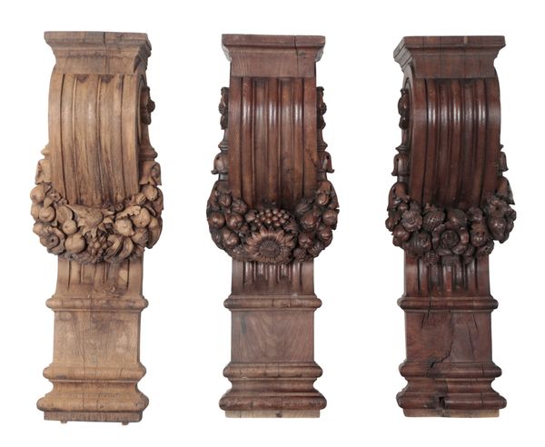 A GROUP OF THREE BAROQUE OAK WALL BRACKETS OR PILASTERS