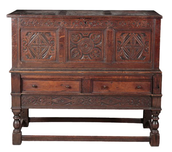 A CHARLES II STYLE OAK CHEST ON STAND