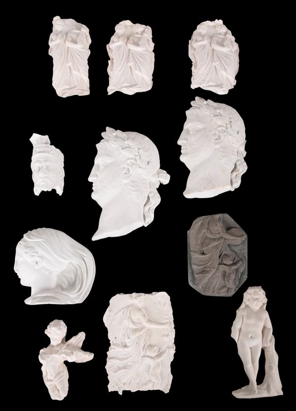 A COLLECTION OF ELEVEN PLASTER RELIEFS