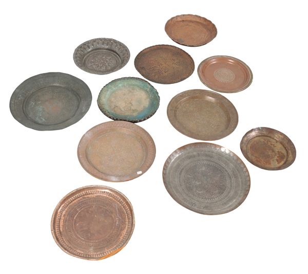 A GROUP OF ELEVEN EASTERN COPPER AND BRASS CHARGERS