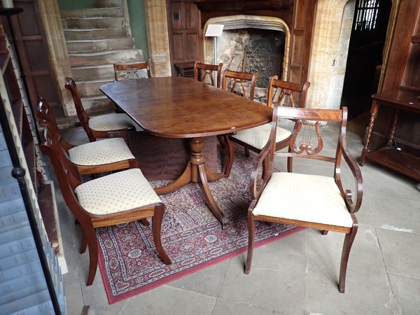 A REPRODUCTION YEW WOOD FINISH TWIN PEDESTAL EXTENDING DINING TABLE OF GEORGIAN DESIGN