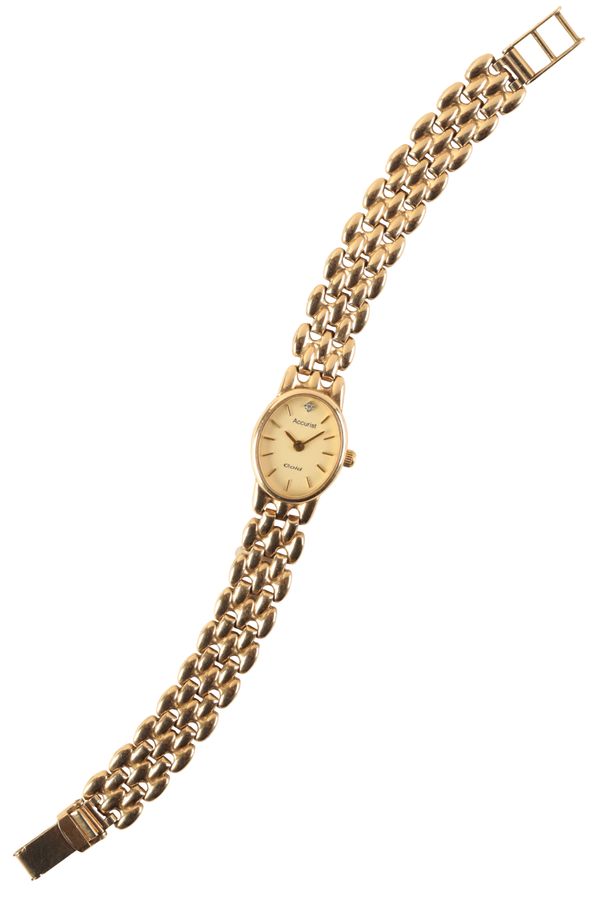 ACCURIST: A 9CT GOLD LADY'S  BRACELET WATCH