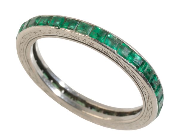 AN EMERALD AND PLATINUM FULL ETERNITY RING