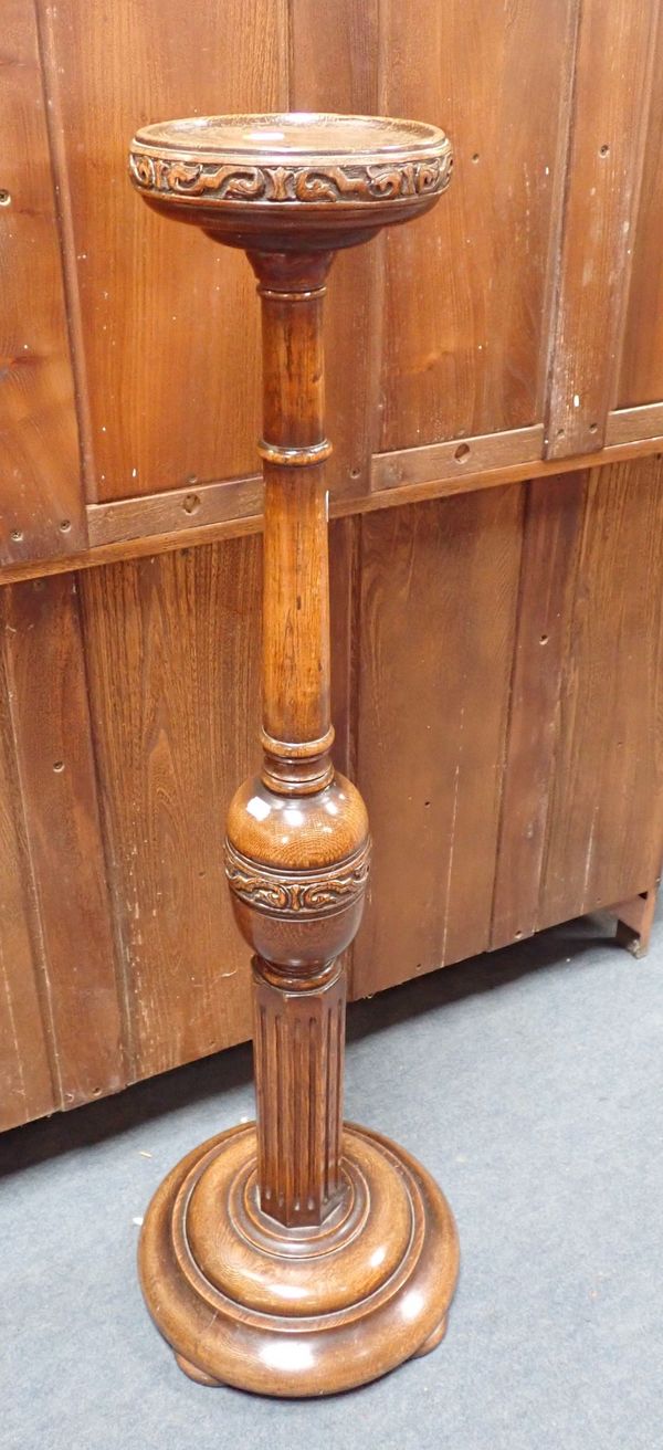 A 1920S TURNED AND CARVED OAK TORCHERE