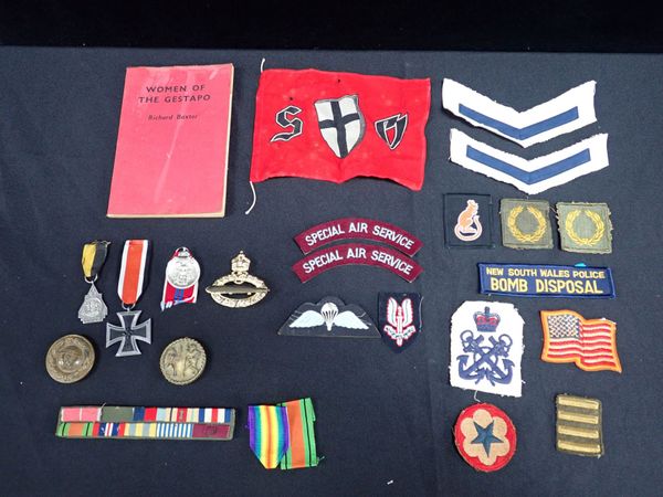 A COLLECTION OF MILITARY BADGES AND MEDALS